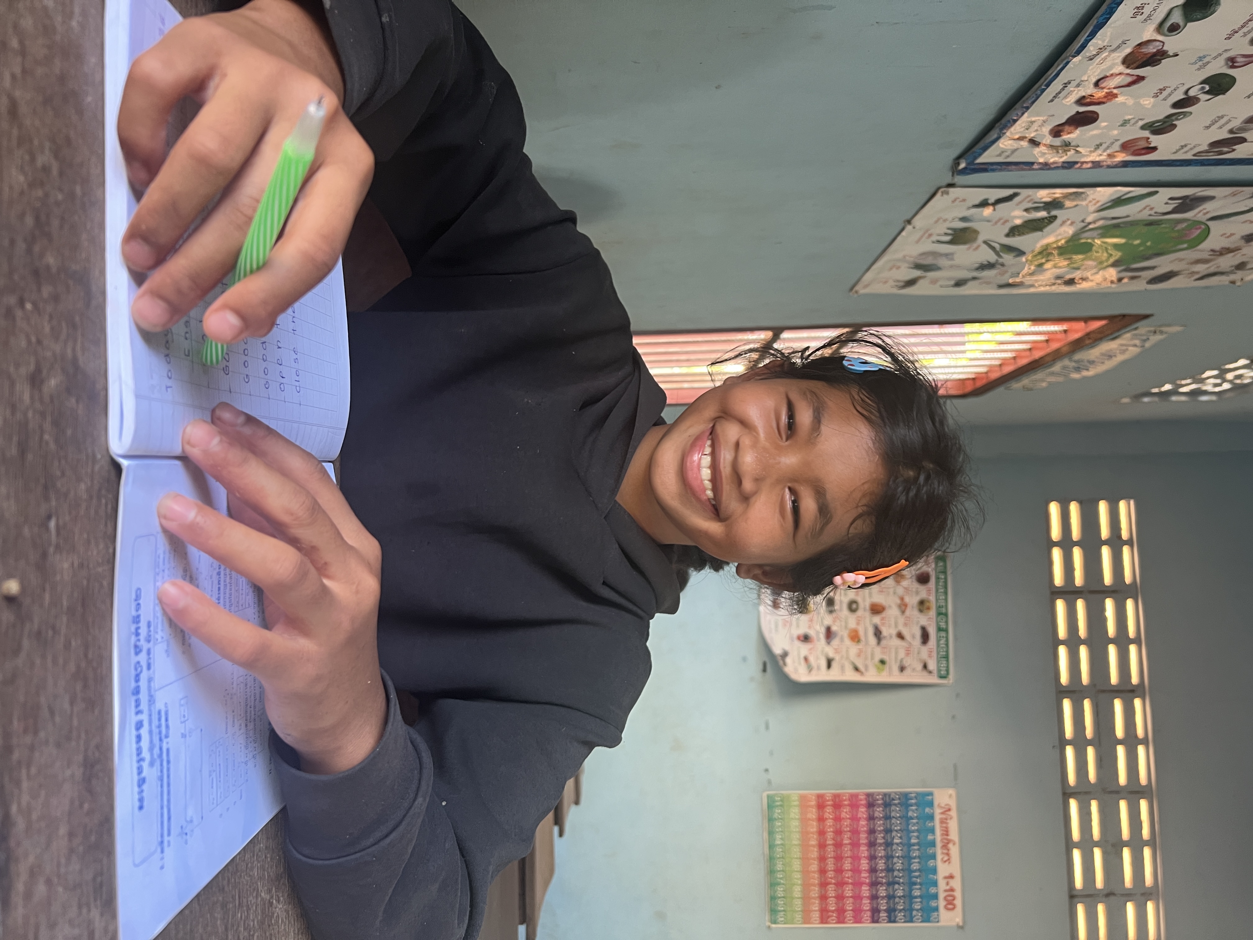 Student smiling at her desk